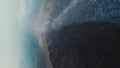 Vertical video. Dive active erupting volcano frozen lava smoke stream disaster