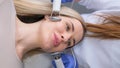 A cosmetologist performs an iontophoresis procedure. Vertical video