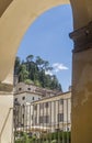 Vertical view of the ancient hilltop village of Cetona, Siena, Italy, framed by an arch