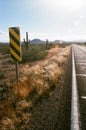 Vertical view of the Arizona 86 highway in Pima County with a hazard sign and cactus in the distance Royalty Free Stock Photo