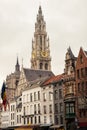Vertical view of bell tower of Cathedral of Our Lady in Antwerp, UNESCO world heritage site in Belgium with flemish houses around
