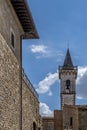 Vertical view of the bell tower of the church of Santa Croce and the walls of the Conti Guidi castle in Vinci, Italy Royalty Free Stock Photo