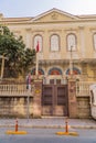 Vertical view of the Beth Israel Synagogue in Izmir, Turkey, with a flag and a tree in front of it