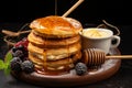 Vertical view captures delectable breakfast croissant, stacked pancakes, cookies on dark table