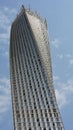 Vertical view of the Cayan Tower, a modern skyscraper with a twisted design in Dubai, UAE