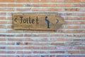 Vertical view of classic simple design handmade wooden sign of toilet give direction to WC , island Bali, Indonesia Royalty Free Stock Photo