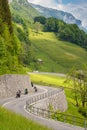 Vertical view of the curvy Klausenpass road in thw Swiss Alps high above the idyllic alpine village of Linthtal