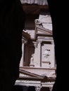 Vertical view of a detail of the Treasury seen between the walls of the siq, the narrow canyon that leads to Petra, Jordan Royalty Free Stock Photo