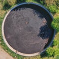 Vertical view down to a large circular tank for the storage of liquid manure Royalty Free Stock Photo