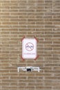 Vertical view of drone flying in a prohibited area and a red sign in the brick wall in the blurred background