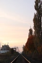 Vertical view of an empty train track leading to a point on the horizon at sunset Royalty Free Stock Photo