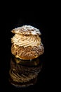 vertical view on french profiterole on black background