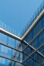 Vertical view of a glass office building in the city center with blue sky above Royalty Free Stock Photo