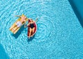 Vertical view of happy couple of old senior people enjoying the summer holiday vacation at the blue water pool with coloured treny Royalty Free Stock Photo