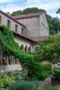 Vertical view of the the L-shaped arcade of the Bonnefont Cloister and garden, part of the Royalty Free Stock Photo