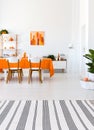 Living room with long table, chairs and orange details. Real photo concept Royalty Free Stock Photo