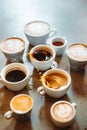 Vertical view of the many cups of coffee standing on stone table Royalty Free Stock Photo