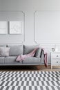 Vertical view of monochromatic living room with grey and white furniture, and patterned rug on the floor Royalty Free Stock Photo