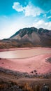 Vertical view of the Nevado Auzangate Mountain with red lake in Peru under cloudy sky Royalty Free Stock Photo