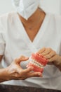 Vertical view of a nurse holding the dentures in her hands Royalty Free Stock Photo