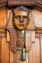 Vertical View of an Old Clapper With Egyptian Faces on a Decorated Wooden Old Door Royalty Free Stock Photo