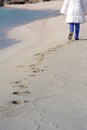 Vertical View of a Person Walking on Sand Making Footprints Royalty Free Stock Photo