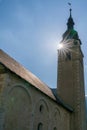 Vertical view of the Protestant church in the village of Spluegen in the Swiss Alps with the sun shining bright