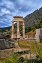 Vertical view of ruins of Tholos of ancient Greek goddess Athena Pronaia in Delphi, Greece. Doric columns. Mt Parnassos Royalty Free Stock Photo