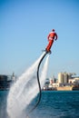 Vertical View of Santa Claus on Flyboard on Blur Background