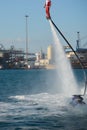 Vertical View of Santa Claus on Flyboard on Blur Background