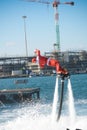 Vertical View of Santa Claus Flying on Flyboard on Blur Background