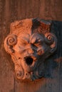 Vertical view of sculpted gargoyle face in Sao Jorge Castle