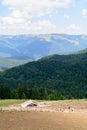 Vertical view with sheepfold and mountains. Wooden sheepfold in Royalty Free Stock Photo