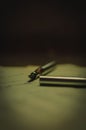 Vertical view of a silver fountain pen over the handwritten paper sheets