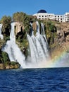 Vertical view of a slightly visible rainbow by the Duden Waterfalls on a sunny day Royalty Free Stock Photo