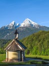 Vertical view of small chapel and snowy summit of Watzmann mount Royalty Free Stock Photo