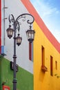 Vertical view of a street lamp and colorful buildings of the Argentinean district La Boca, in Buenos Aires, with old