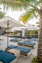 Vertical view of sunbeds and umbrellas near swimming pool at beach Royalty Free Stock Photo