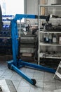 Vertical view of the tool for auto service. Blue crane for repairing the engine and gearbox of the car in the workshop for the Royalty Free Stock Photo