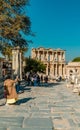 Vertical view of tourists walking to the Library of Celsus in Ephesus.