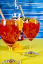 Vertical view of two glasses of the refreshing aperol spritz cocktail with mint and orange leaves. Selective focus Royalty Free Stock Photo