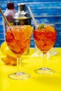 Vertical view of two glasses of the refreshing aperol spritz cocktail with mint and orange leaves. Selective focus Royalty Free Stock Photo