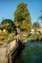 Vertical view of wheel of water mill in Medieval village L`Isle-sur-Sorgue, Vaucluse, Provence, France. Famous Sorgue river with Royalty Free Stock Photo