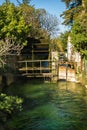 Vertical view of wheel of a water mill in Medieval village L`Isle-sur-Sorgue, Vaucluse, Provence, France. Famous Sorgue river wit Royalty Free Stock Photo