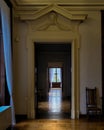 Vertical views through row of open doors in a house with sunlight coming from the window