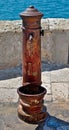 Vertical of a vintage old rusty fountain.