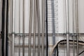 Vertical wall mounted pipes and electrical cables in an industrial setting. Front view, no people Royalty Free Stock Photo