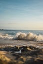 Vertical of a wave crashing onto a shore on the beach in Oahu, Hawaii. Royalty Free Stock Photo