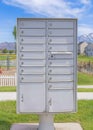 Vertical Whispy white clouds Cluster pedestal maibox near the playground and lake in a residential area at Utah valley