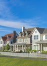 Vertical Whispy white clouds Neighborhood houses with gable roof and front porches at Daybreak, Utah Royalty Free Stock Photo